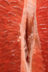 Detailed close-up photo of juicy red grapefruit slices. Macro photo of citrus fruits