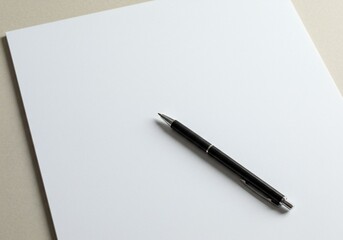 Minimalist setup featuring a blank white sheet of paper and a black pen on a beige background, emphasizing simplicity and potential.