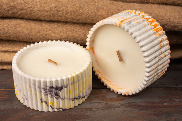 A set of different aroma candles. Scented handmade candle on a wooden background. Soy candles Aromatherapy and relax in spa and home. Still life.