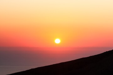 A colorful sunset sky with vibrant orange and pink colors. The peaceful twilight atmosphere is...