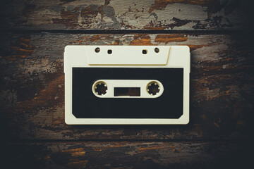 Old audio cassette on a wooden background. Close up white audio cassette.