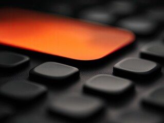 Close-up of a dark gray keypad with a highlighted orange square