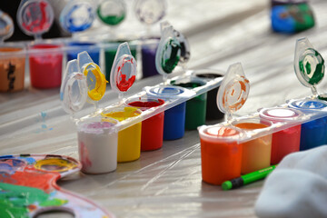 art supplies box of colorful paints in jars brush pencil drawing art hobby passion