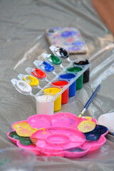 art supplies box with colorful paints in jars brush pencil palette drawing art hobby passion