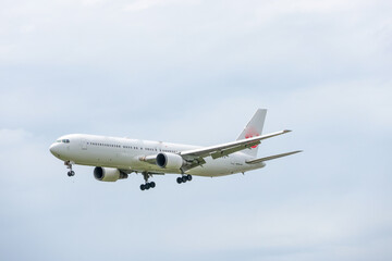 Passenger Aircraft Landing At Fukuoka Airport On Bright Summer Day