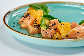 A Vibrant Plate of Fresh Salmon and Citrus Segments Garnished with Herbs and Seasoning, Showcasing a Colorful Culinary Presentation