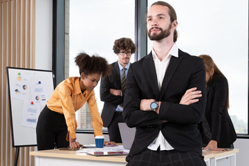 Diverse Team Working Together in Modern Co-Working Space. Casual meeting of smiling diverse business team analyzing financial data. Multiethnic business people working together in the office.