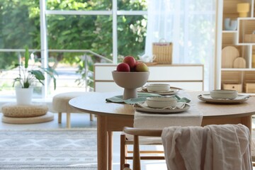 Stylish table setting with fresh fruits and decor in dining room. Interior design