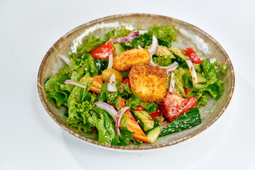 A vibrant and nutritious salad featuring fresh greens, colorful vegetables, and crispy elements that enhance its refreshing taste and visual appeal.