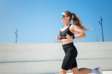 Energetic woman enjoying her morning run at the outdoor track