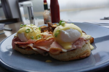 Eggs Benedict Brunch with Crispy Hashbrowns on White Plate
