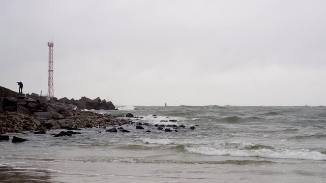 Baltic seascape. Entrance to Klaipeda seaport. Dark and stormy waves rolling and crashing. Slow motion footage. Lithuania.