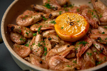 Deliciously Cooked Shrimp with Citrus Garnish in a Sizzling Pan Full of Flavor and Freshness Perfect for a Gourmet Seafood Dish