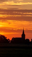 Naklejka premium Sunset over church silhouette