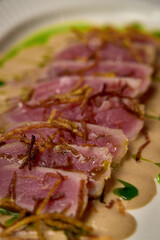 Succulent Slices of Seared Tuna Accompanied by Crispy Garnishes and Rich Sauce Creating a Gourmet Culinary Delight for Seafood Lovers