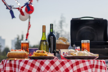 Chilean Independence Day: Traditional food table with completos, empanadas, sopaipillas, wine and chicha during Independence Day