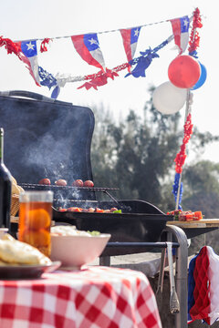Chilean Independence Day: vertical view of barbecue and decorations with anticuchos and longanizas