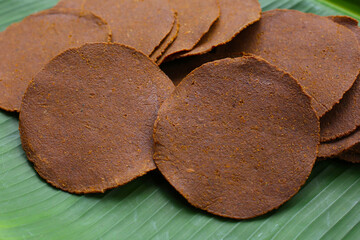 Sun-dried fermented soybean sheets called “Thua Nao,” a traditional ingredient in Northern Thai...