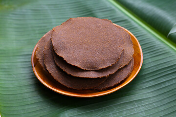 Fermented soybean discs, known as “Thua Nao,” a traditional Thai seasoning used to enhance flavor in Northern cuisine.