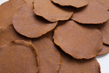 Fermented soybean discs, known as “Thua Nao,” a traditional Thai seasoning used to enhance flavor in Northern cuisine.