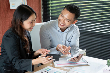 Collaborative Discussion Between Colleagues. Two professionals sharing insights and ideas in a modern office.