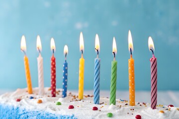 Lighted birthday candle wax photographed up close against a blue background. design illustration