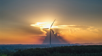 Sunset with Wind Turbine in a Scenic Landscape