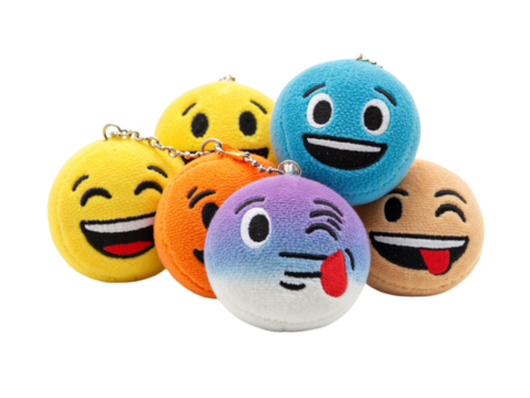 A group of colorful round plush emoji toys with different expressive faces isolated on transparent background