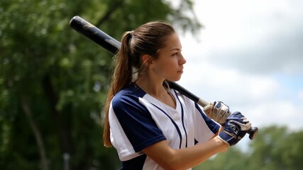 Young girl ready to play baseball, in sportswear holding bat - Powered by Adobe