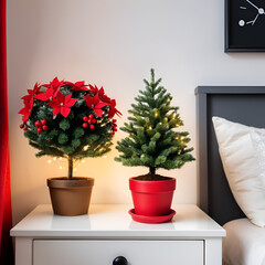 Small miniature evergreen fir Christmas tree with garland in a red flower pot on a wooden night stand in a decorated bedroom. Holiday diy home interior design. Stay and celebrate at home.