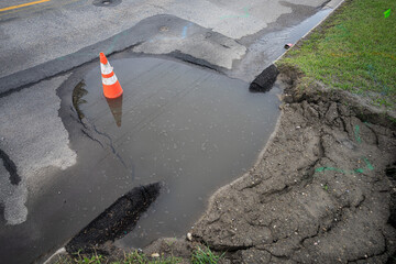 Sinkhole on a road with Traffic Cone