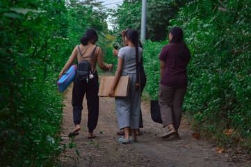 As they walk along the wooded trail, the girls share smiles and conversations, enjoying both the...