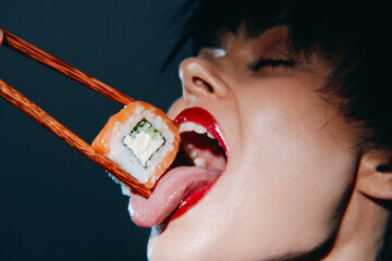 Sensual woman enjoying sushi with chopsticks, vibrant colors, close-up, playful mood, focus on food...