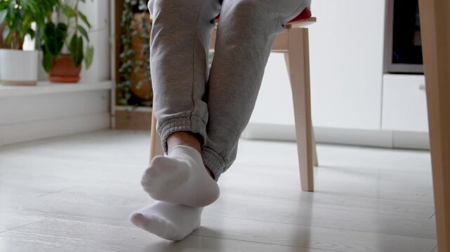 Nervous foot tapping legs crossing twitching on chair, attention deficit disorder, concentration problems, hyperactivity spasms seizures. Restless legs syndrome, fidgeting behavior, neurological issue