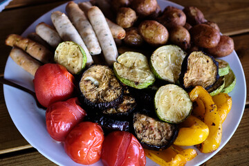 Delicious grilled vegetables and assorted sides served on a plate at a summer gathering