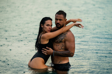Romantic couple kissing in the sea. Tender beautiful couple in love. Outdoor shot on nature of...