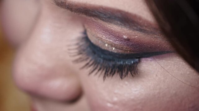 Beauty makeup application close up with dramatic lashes