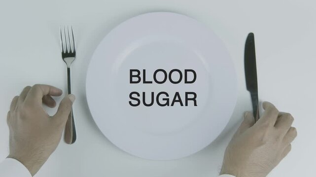 Blood Sugar written on a plate with a hand holding a fork and knife against a white background, symbolizing glucose levels, nutrition, dietary balance, and health management