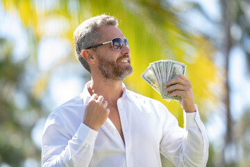 Rich businessman holding cash. Successful rich man counting dollar bills. Rich business man with...