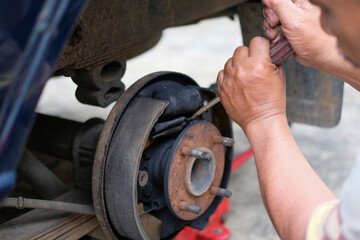 Mechanic working on vintage car brakes