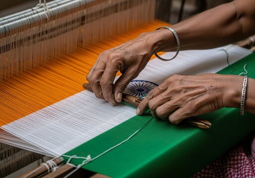 Hands weaving Indian flag on traditional loom showcasing textile craft