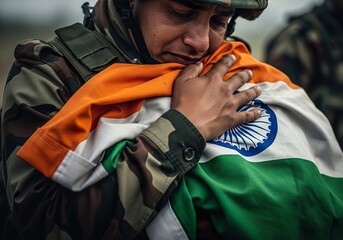 Emotional Indian soldier embracing national flag patriotism and sacrifice military service