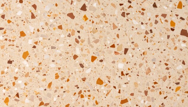Superficie de terrazo beige con incrustaciones marrones y naranjas, textura moderna