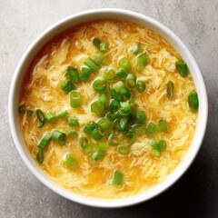 Egg drop soup in a white bowl.