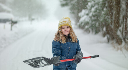 Kid clearing sidewalks and shoveling snow. Child removing snow with shovel. Little helper. Winter kid play with snow. Little boy with a shovel to clear the snow. Winter season, snowy weather, cold.