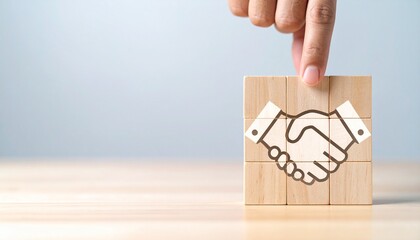 hand places final block into handshake puzzle symbolizing agreement and partnership