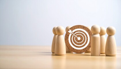 Wooden figures gather around a target board with an arrow, symbolizing goal alignment and teamwork