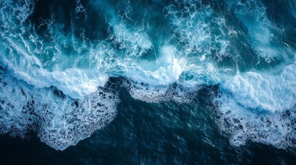 Obraz premium Dynamic top view of crashing sea ocean waves creating vibrant turquoise patterns with white foam, representing nature force, aquatic textures, and beautiful oceanic energy in coastal environment