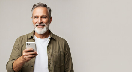 Smiling mature man using a mobile phone.