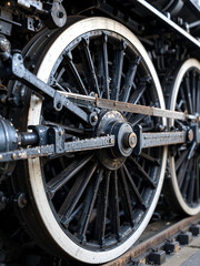 Intricate details of vintage locomotive wheels and mechanical linkages